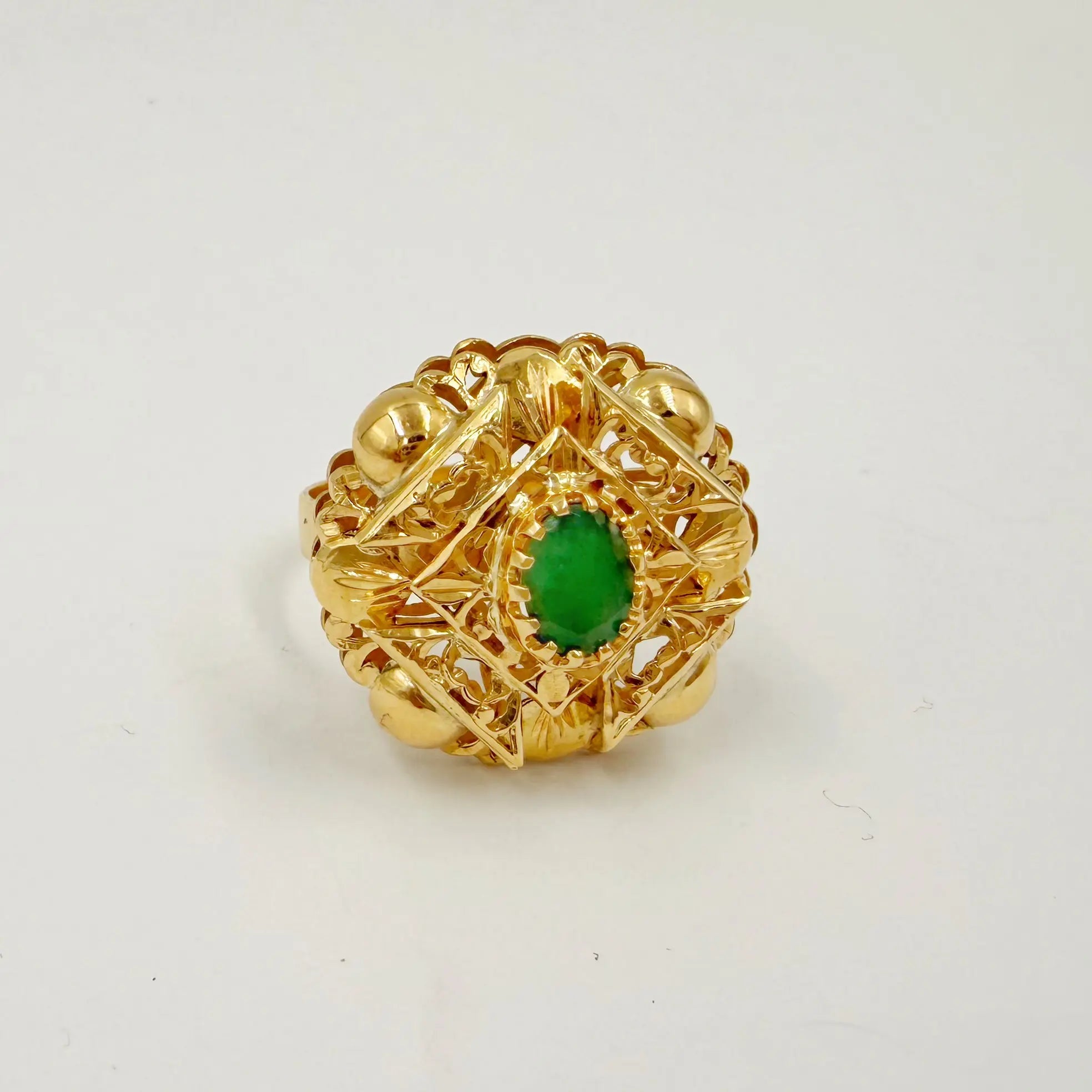 Bague traditionnelle en or rose sertie d'une pierre verte